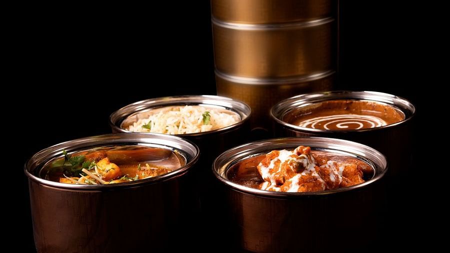 Image of various dishes packed in tiffen boxes at  The Claridges New Delhi