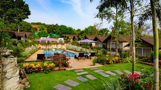 The garden with blooming flowers and the cottages at our resort in Mandrem 