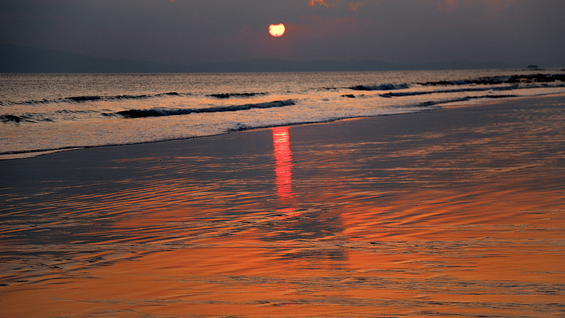 A view of the sunset at Radhanagar Beach with the reflection of the sun seen on the shores of the beach.