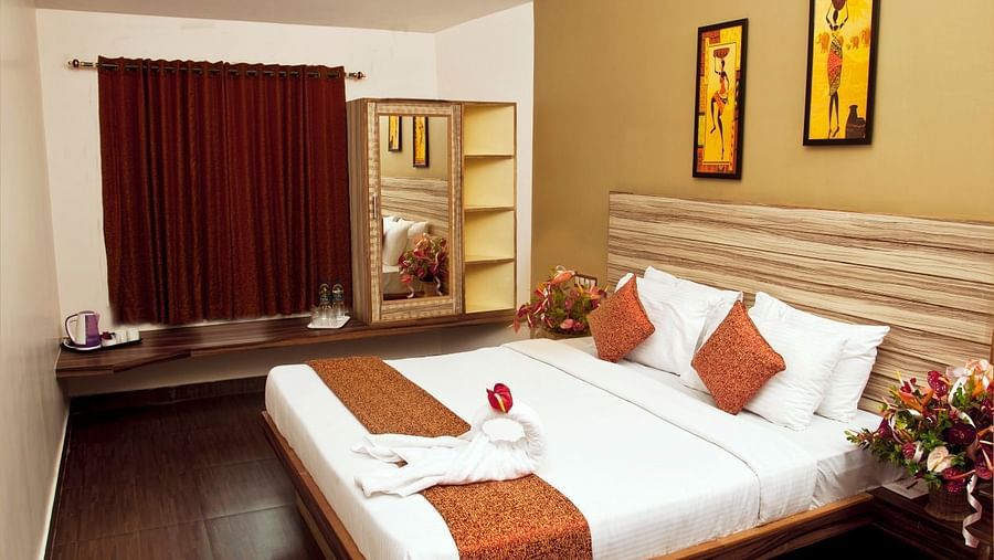 Flora Suite bedroom with a double bed and a wardrobe