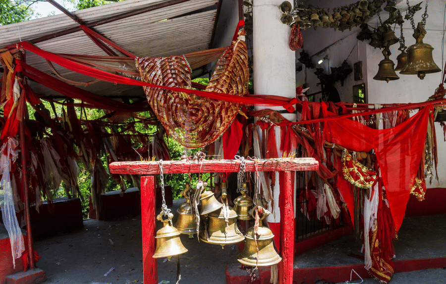 An image of temples bells in a traditional indian temple.