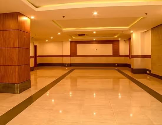 View of a spacious banquet hall with polished flooring and warm lighting - Max Hotel Prayagraj