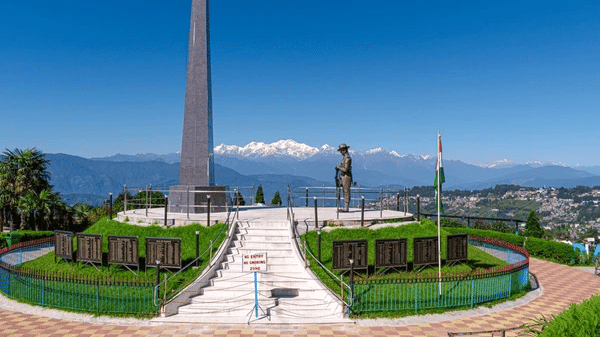 A landscaped garden at Batasia Loop in Darjeeling with a central war memorial.
