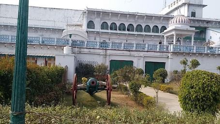 A facade image of FORT REWA with a decorative canon gun in the front lawn
