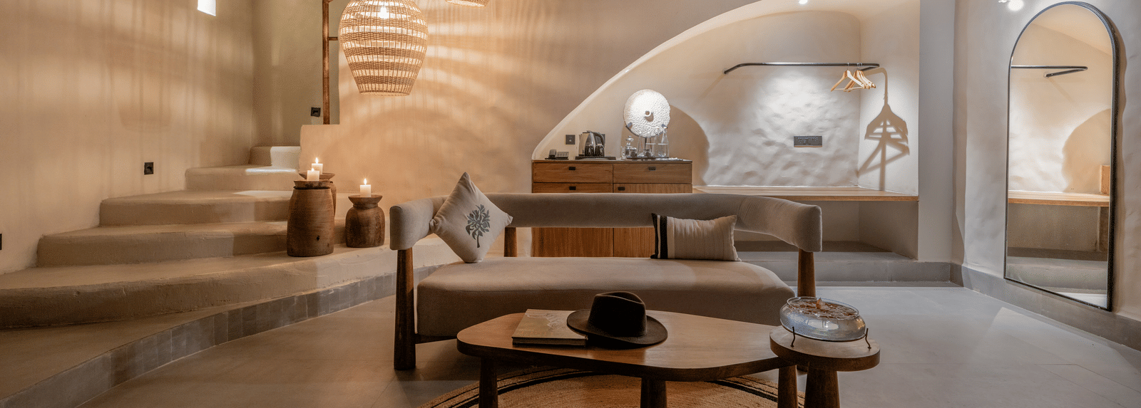 Spacious living room with large windows, woven pendant lights, and earthy decor.