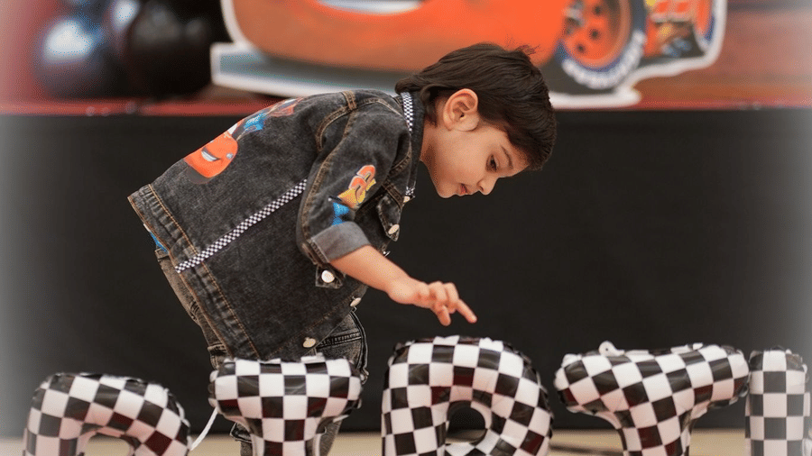 A child posing with a Cars-themed birthday setup at La Maison Hotel, Doha.12-10 at 15.43.17 (3)