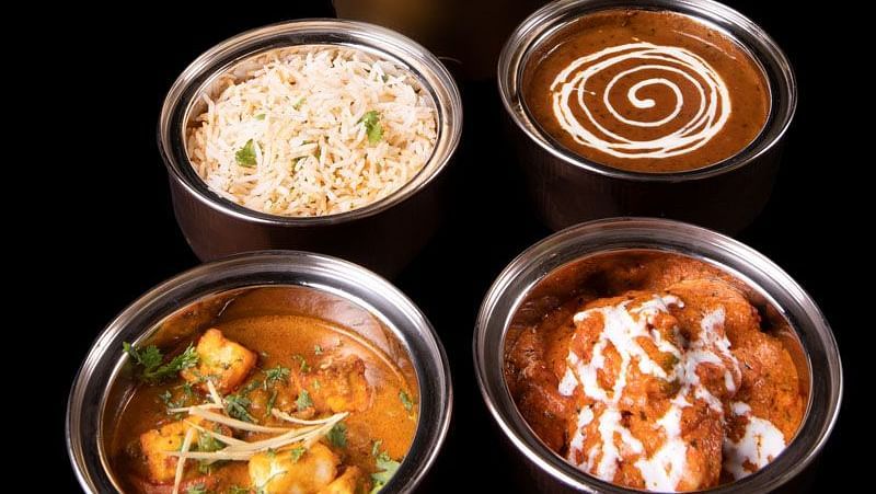 image of a tiffin served at  The Claridges New Delhi with delicious food items