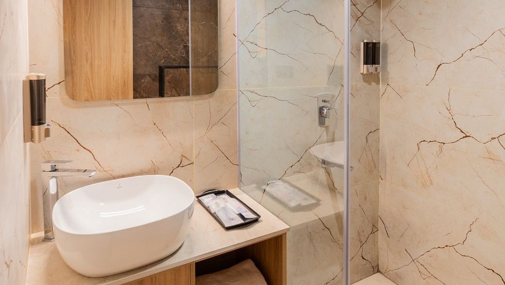 Washbasin and mirror in The Premium Rooms at TGI Livancia The Sojourn, Bangalore.