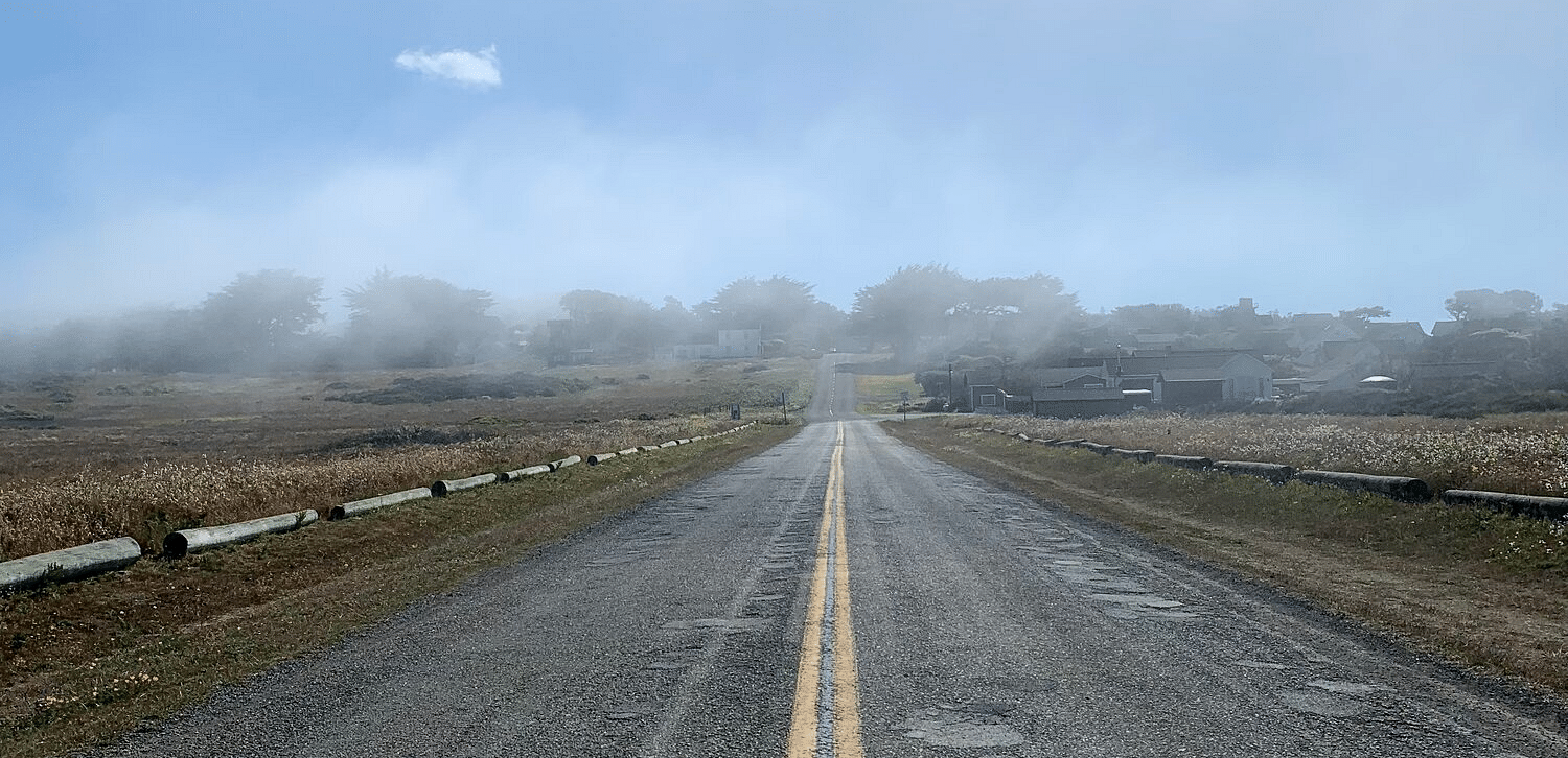 A foggy road with a line in the middle