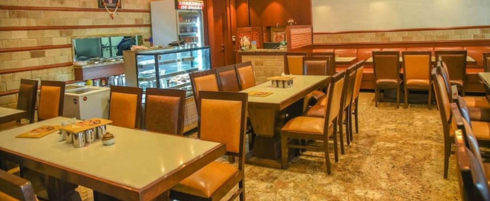 Casual dining space at BluSalzz Select - City Centre, Amritsar with wooden furniture and bright ambiance.