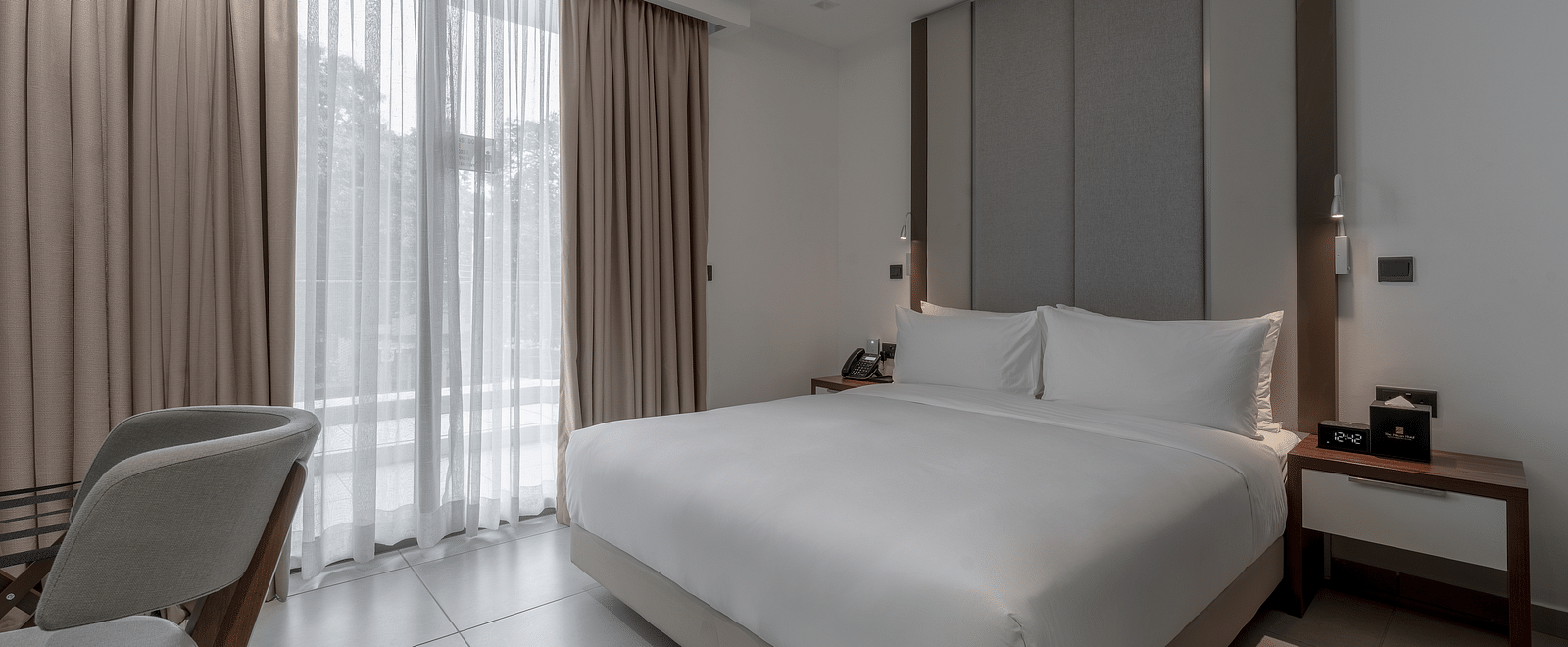 Luxurious Premier Suite offers a king bed, modern decor, and elegant furnishings for a relaxing stay. - The Pelican Hotel, Accra