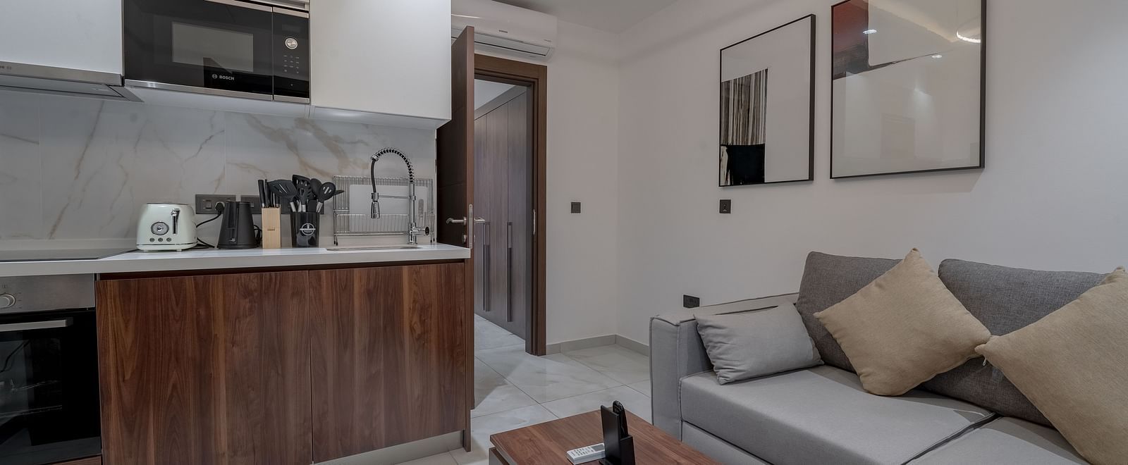 A modern, spacious Deluxe Room with sitting area, and kitchenette. - The Pelican Hotel, Accra