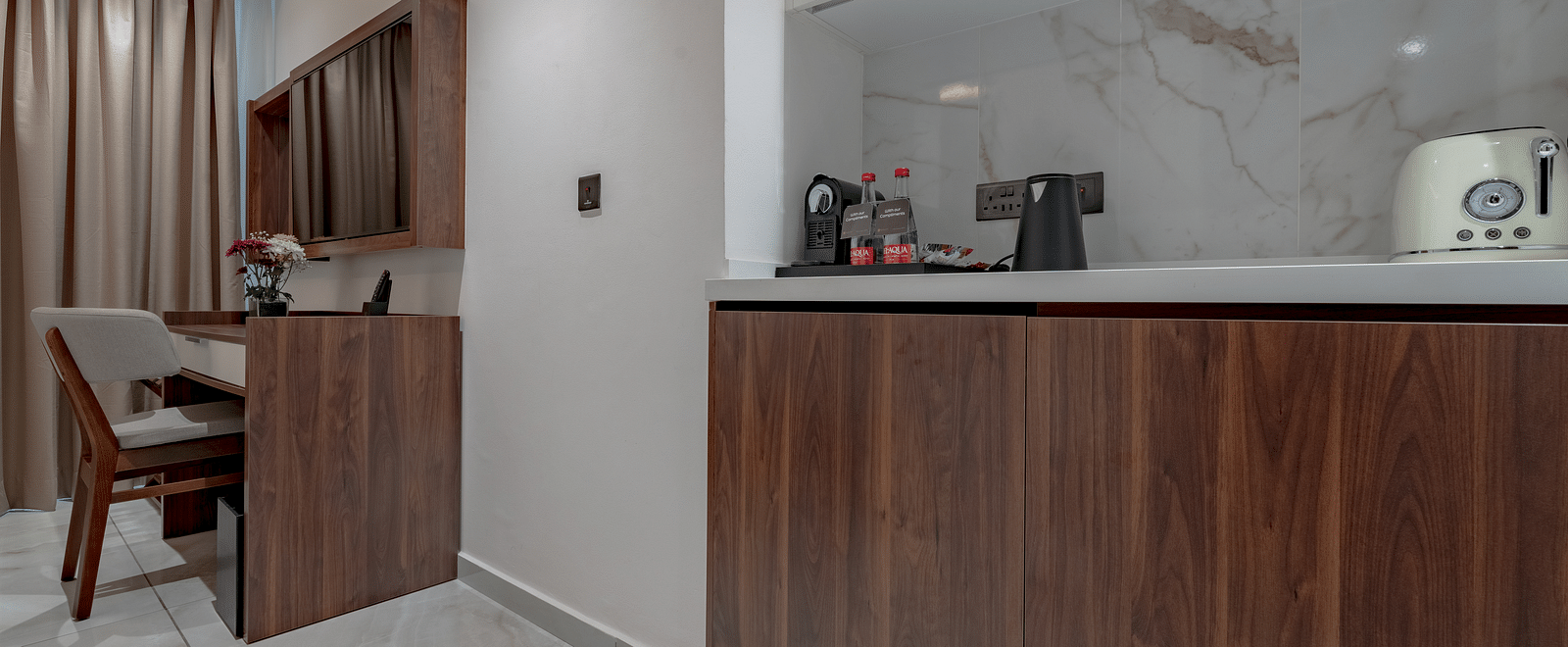 Standard Room with wooden desk, minibar, kettle, toaster, marble backsplash, and elegant lighting. - The Pelican Hotel, Accra