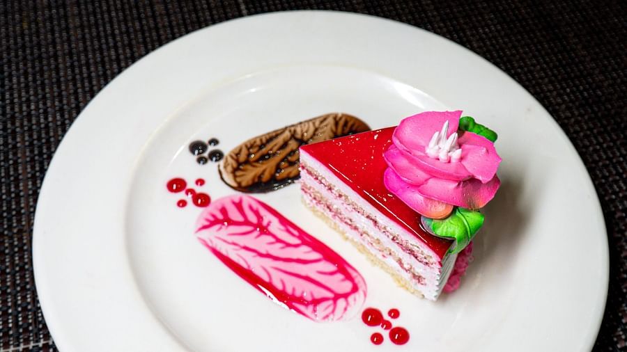 A plate with a slice of cake decorated with red and white frosting.