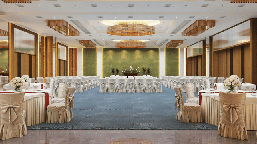 A full-view shot of an expansive banquet hall with blue carpet covering the space, along with chairs arranged in theatre setting at Essentia Luxury Hotel and Convention, Nagpur.
