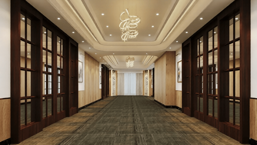 Full view of the corridor at the Essentia Luxury Hotel and Convention, Nagpur, covered by carpet flooring.