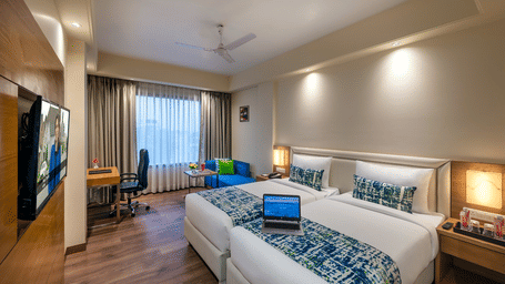 Spacious Club room with sleek wooden flooring, minimalist lighting and a TV