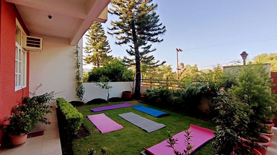 garden with pink and blue yoga mats @ Lamrin Boutique Cottages, Rishikesh