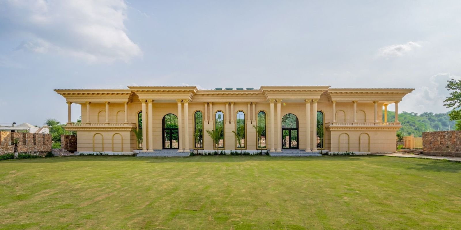 Facade of The Royal Know Banquet Hall at Valley by Grassfield, featuring large windows and a spacious open area in front.