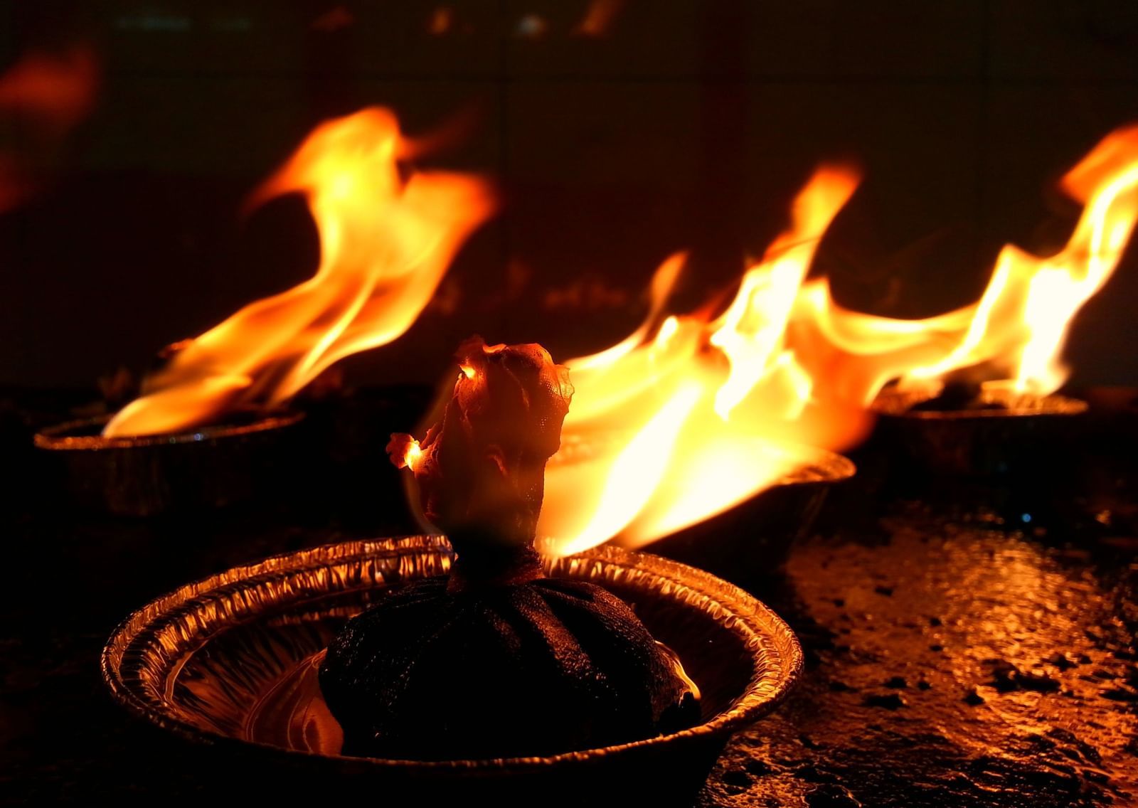 A close up of two lit diyas to symbolise Karthigai Deepam Celebration.