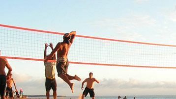 people playing beach volleyball at South Goa resort with private beach - Caravela Beach Resort, Goa