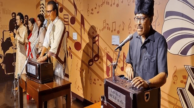 Lifelike wax statues of legendary Indian musicians and singers performing with instruments at Mother's Wax Museum in Kolkata.