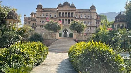 Entrance to Patan Mahal covered in lsuh green garden
