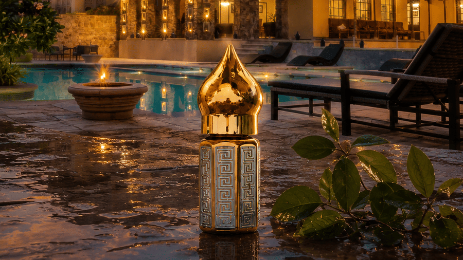 Juna Mahal signature attar bottle beside a pool, reflecting the warm ambience of the property after rain in Ranthambore.