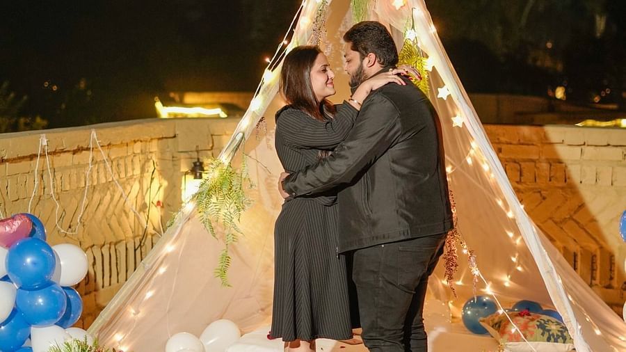 A couple dancing beside a well-lit tent at Themis Mudhouse - A Nature's Retreat Resort & Wellness