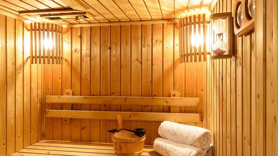 image of the sauna with warm light and rolled towels - Maikhao Dream Villa Resort & Spa, Phuket