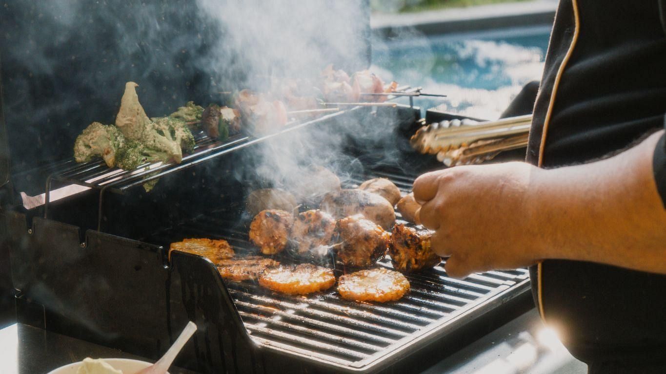 Picture of a sizzling BBQ table a chef preparing BBQ
