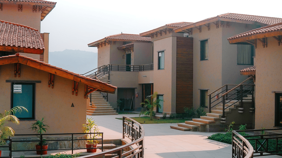 A charming pathway winding between the resort buildings at Aamaghati Wildlife Resort.