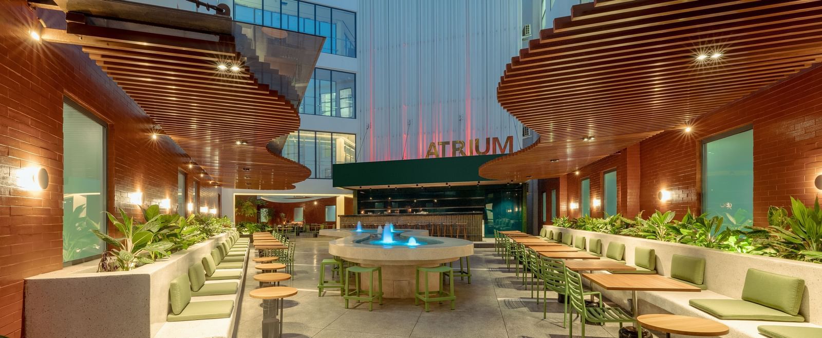 Outdoor dining setup at Atrium restaurant, The Pelican Hotel, Accra, with cosy seating and warm lighting.