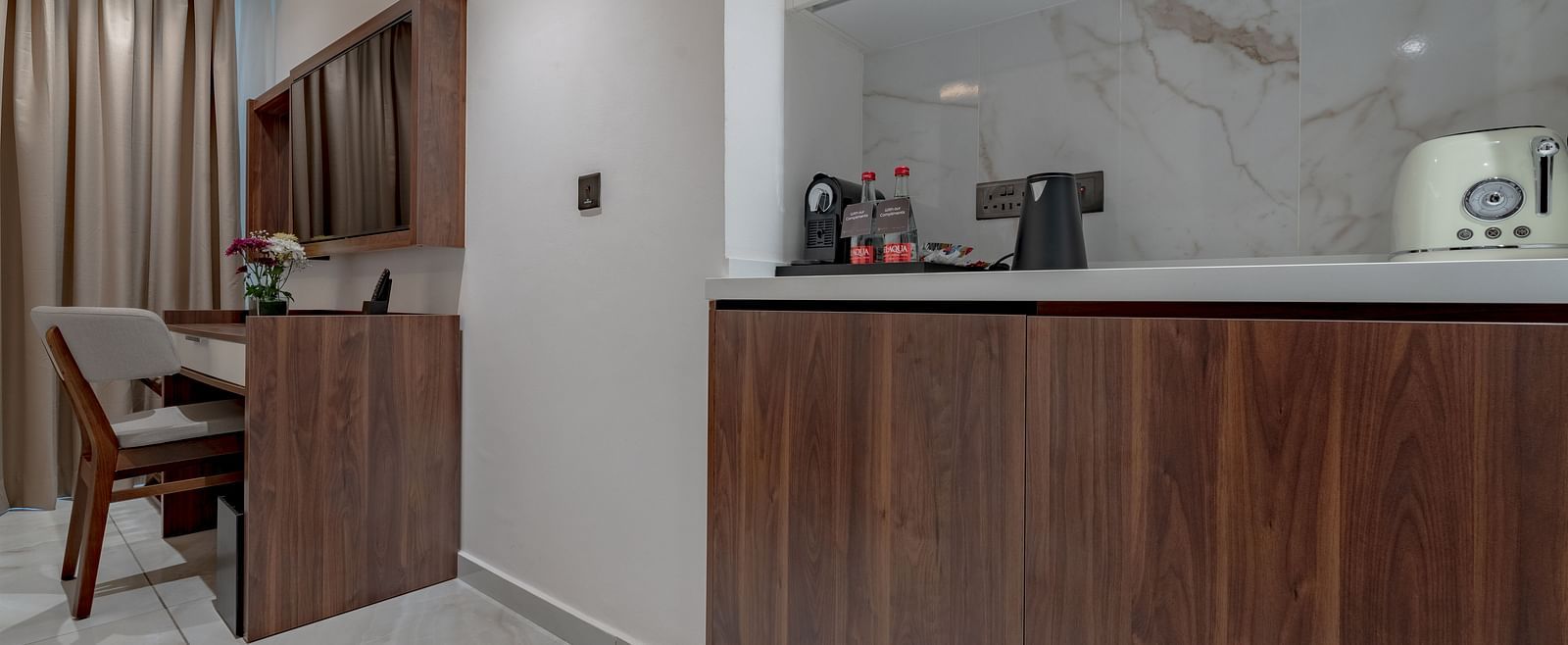 Standard Room with wooden desk, minibar, kettle, toaster, marble backsplash, and elegant lighting. - The Pelican Hotel, Accra