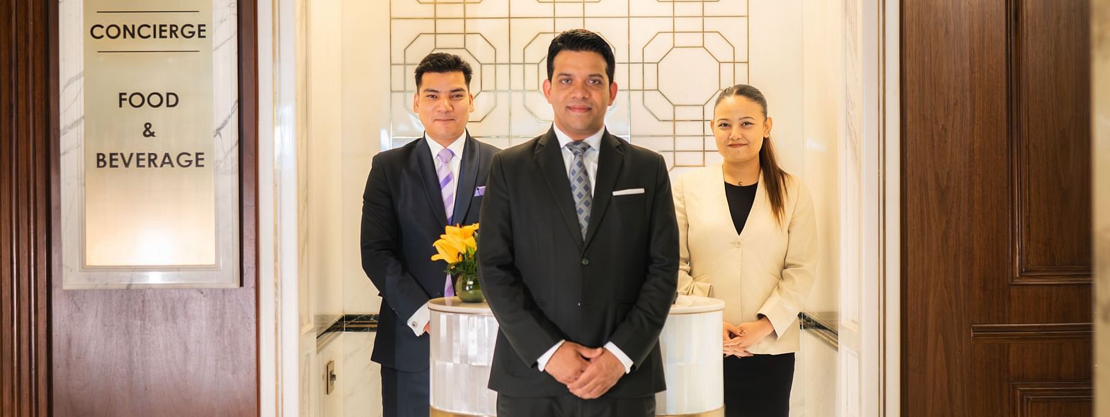 Image of three Concierge posing for a photo at The Claridges - Claridges Collection