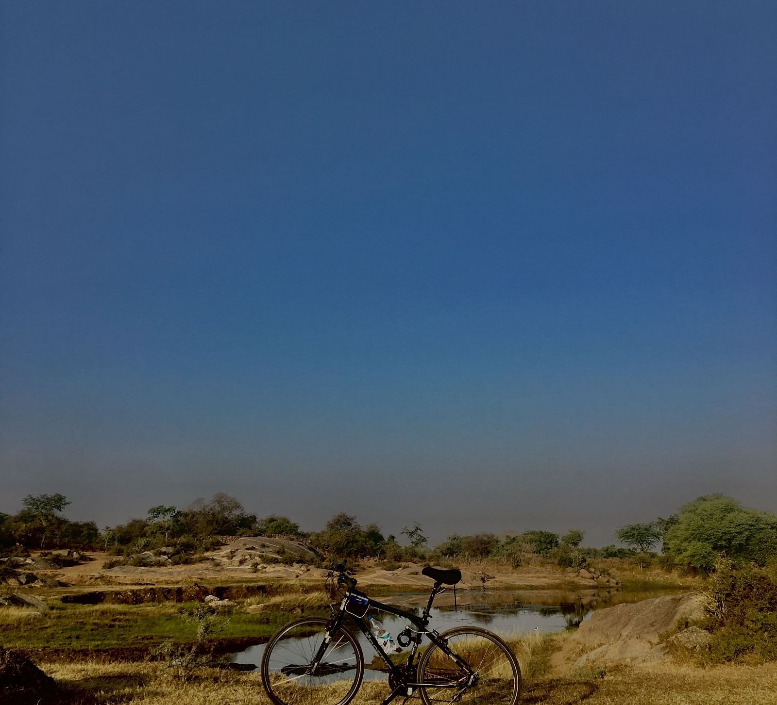 image of a cycle parked in an open grassland