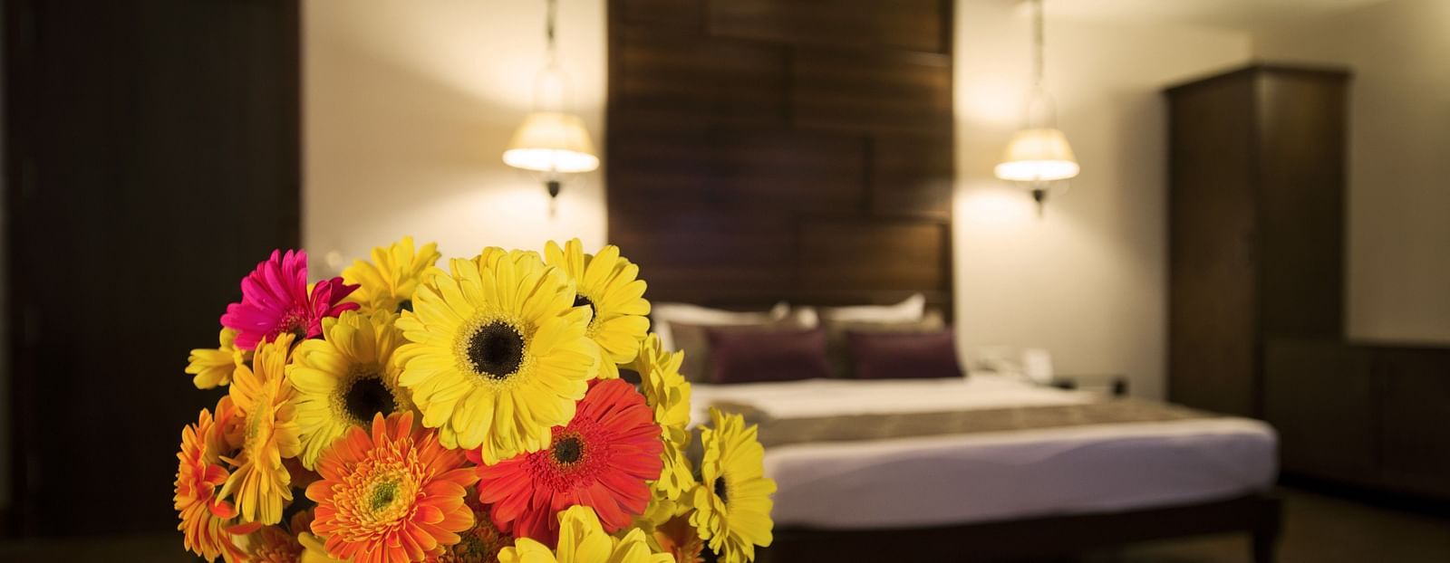 A flower vase in a room with a bed | The Manor, Kashipur