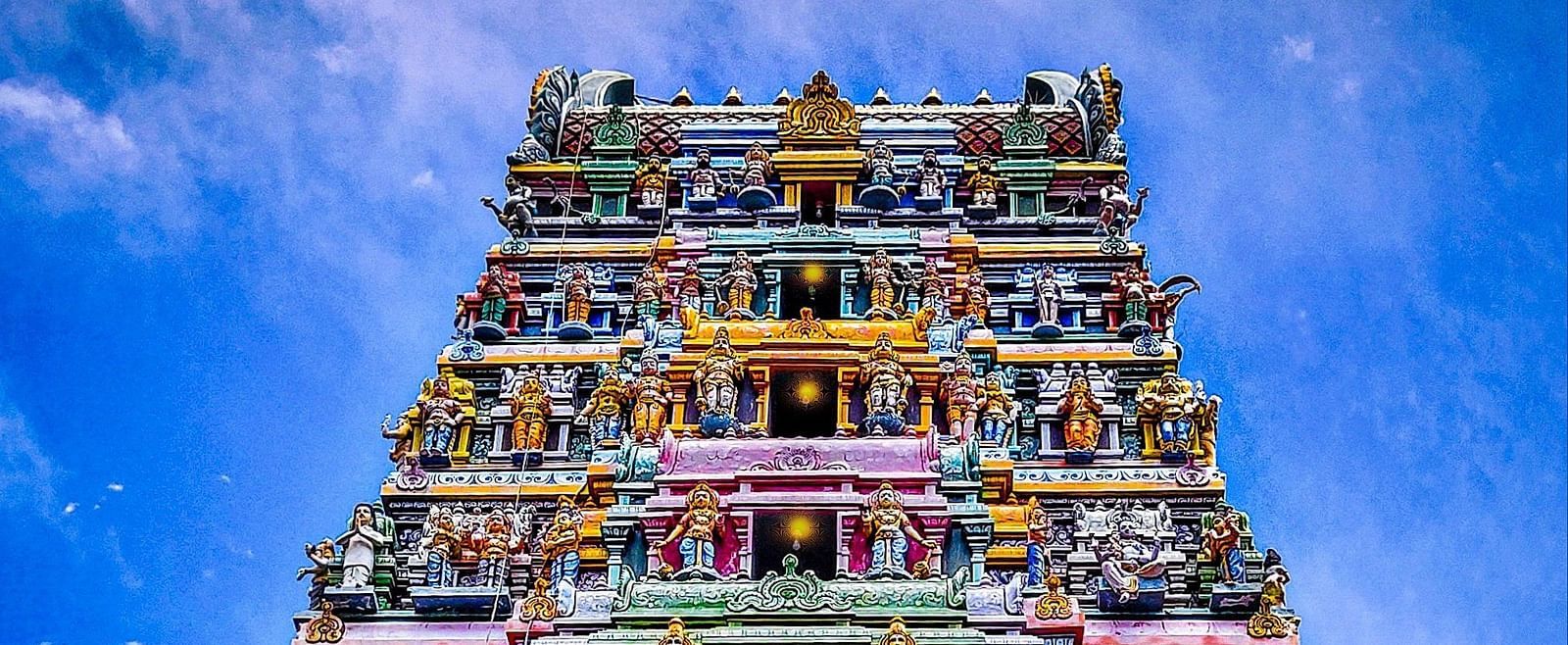 An overview of a temple in Salem with intricate art on the roof of many Hindu deities.