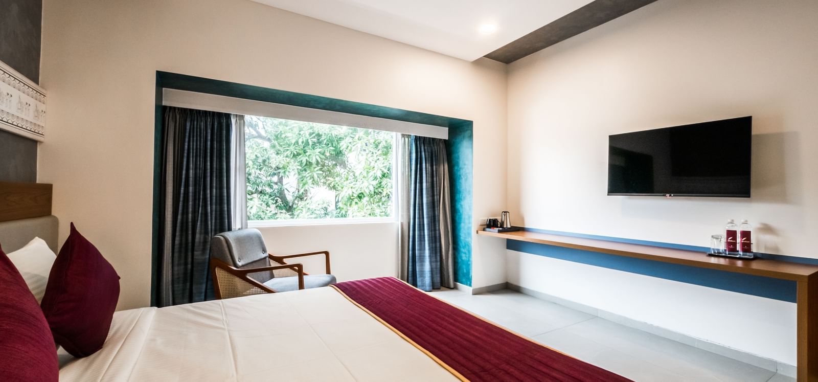 A view from the bed in a hotel room, showing the television and a long console table at Shilton Dee Cee.