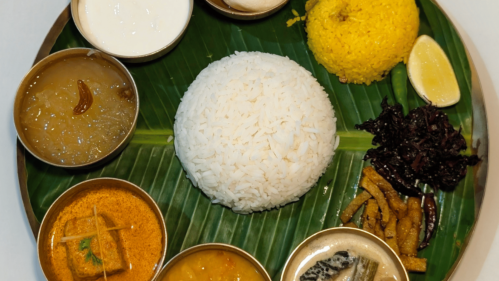 Indian vegetarian thali with rice, curries, and sweets at Dip Holidays.