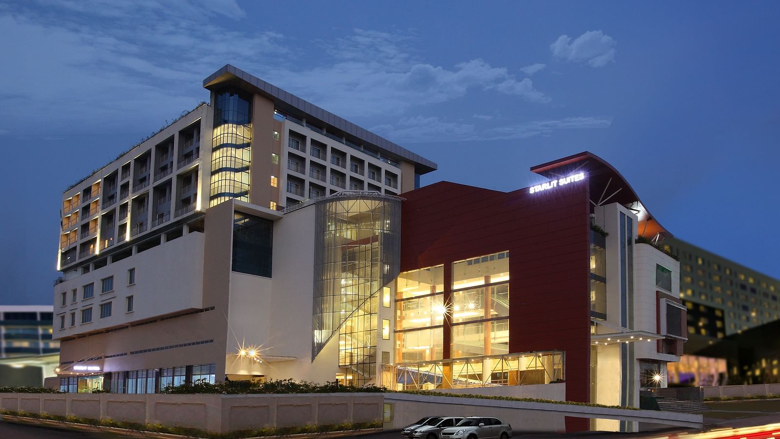 Facade image of Starlit Suites, Kochi in the evening with the lights on