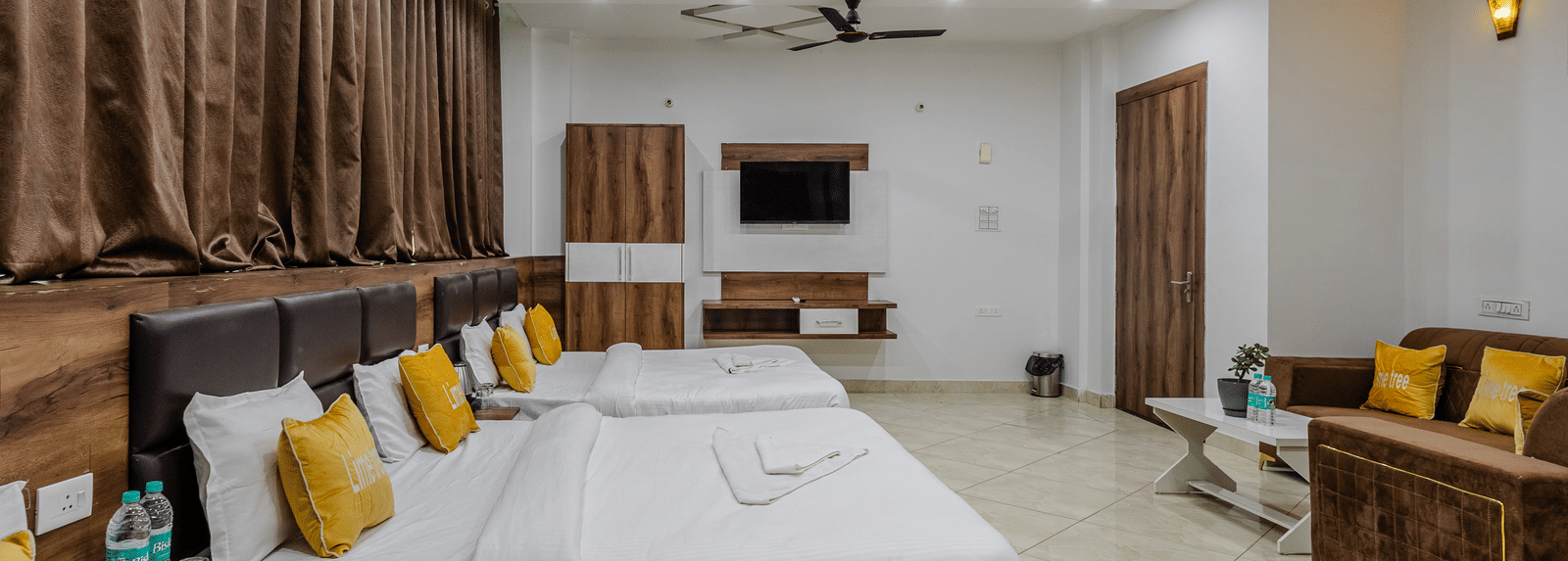 A side view image of the Brij Royal Family Suite with lined up double beds at Lime Tree Hotels and Banquet, Vrindavan.