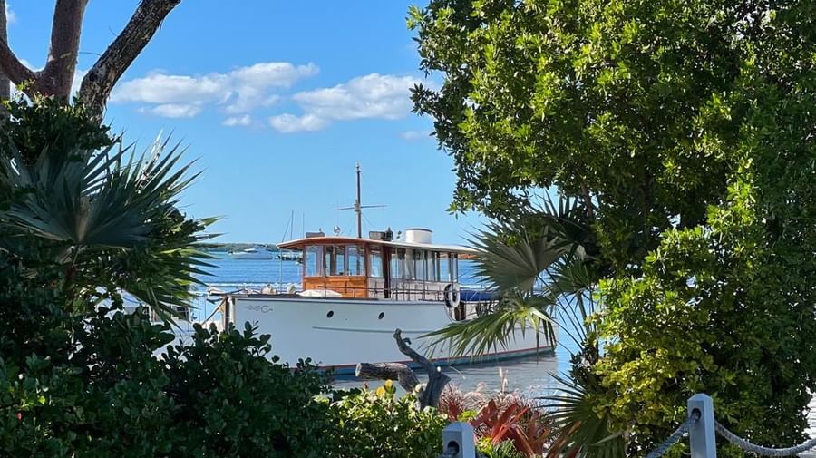 The Blue Mist sailboat standing still amid tranquil waters below a clear blue sky at Casa Morada.