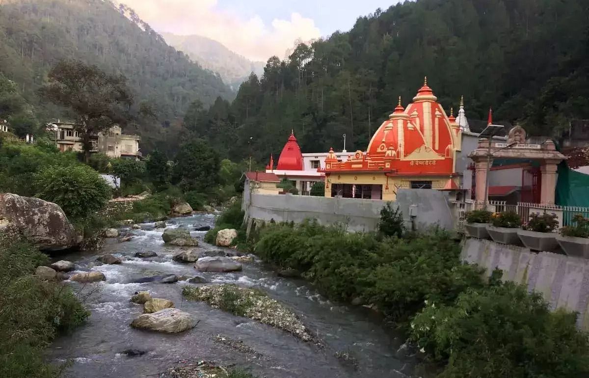 An image of a temple near a stream