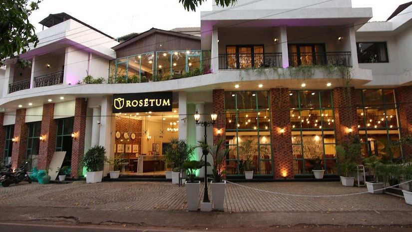 Facade of Rosetum Anjuna in the morning with a pavement in front of the hotel in view.
