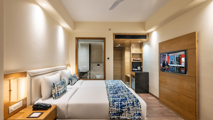 Club room with a king size bed, smart TV, and a sleek modern design 