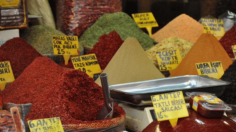 Assorted Indian spices in bright colours displayed in a market stall.