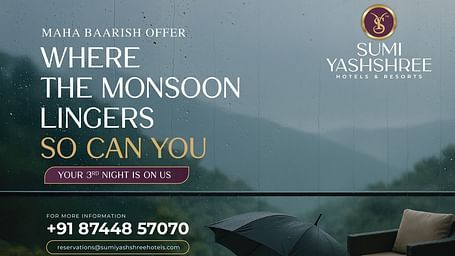 Rainy terrace with umbrella and chair promoting Sumi Yashshree's monsoon offer – third night free at select hill destinations.