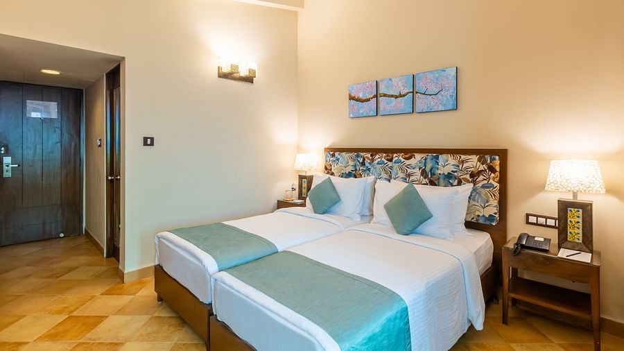 room with twin beds in goa at Heritage Village Resorts and spa