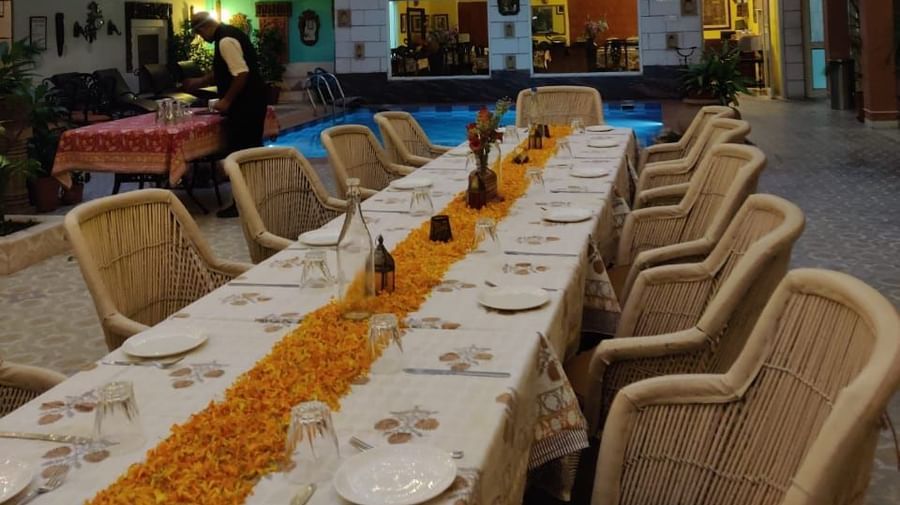 Seating arrangement with fairy lights on the top at Alfresco Dinner at the courtyard at Suryaa Villa Jaipur